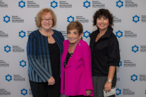 Three women smiling
