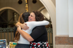two women hugging and smiling