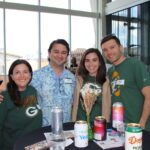 Group of young adults at an event wearing Green Bay Packers shirts