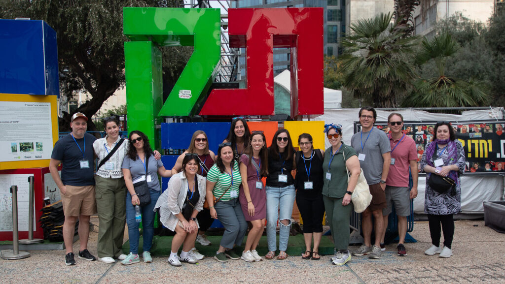 Group of young adults standing in front of a statue in Israel