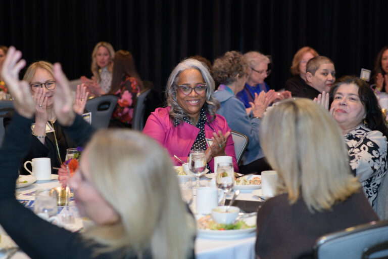 room of women clapping