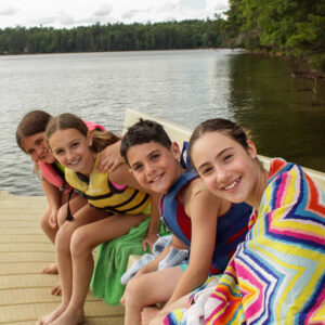 young kids by the lake at camp