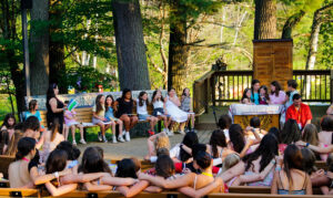 young campers gathered outside arm in arm