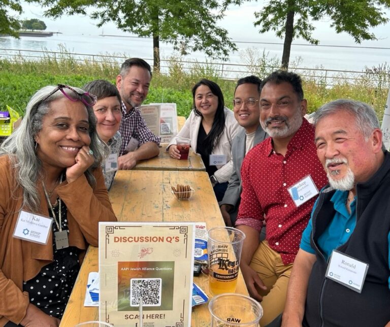 Diverse group of people smiling at a picnic table