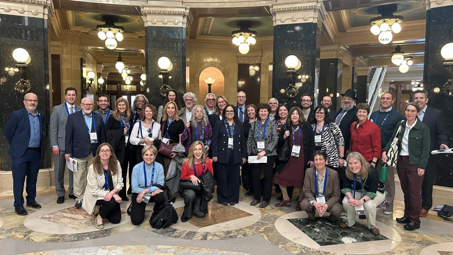Group of people smiling at the capitol building