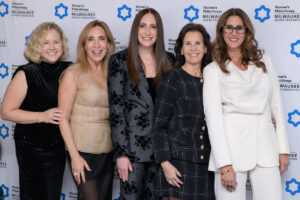 A group of women at a special event smiling
