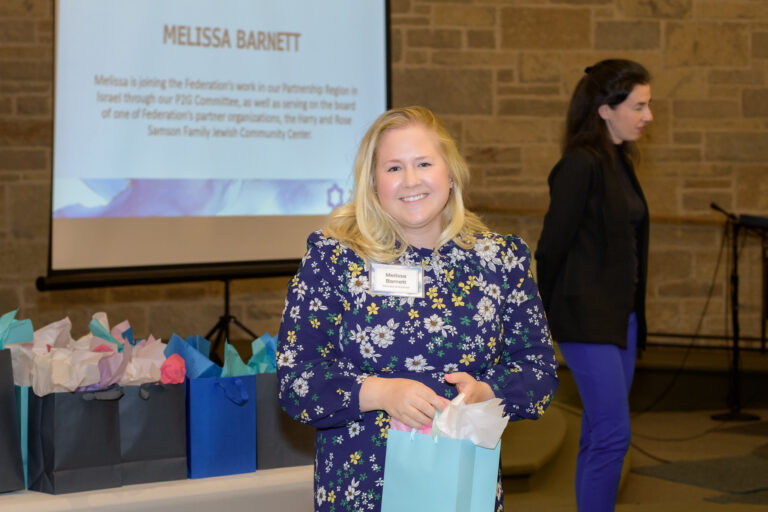 young adult woman holding a gift bag
