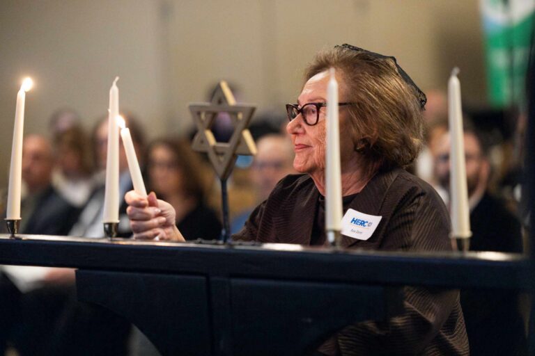 a woman lighting a candle