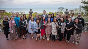 Large group of young adults standing outside at an event smiling