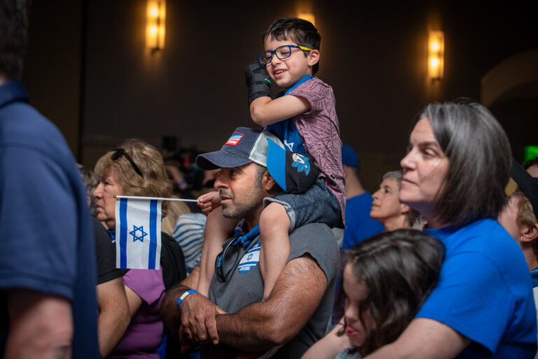Boy sitting on father's shoulders