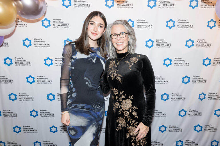 Two women at an event smiling
