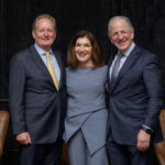 three professional business leaders smiling