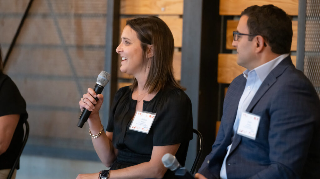 A woman speaking on a microphone at an event