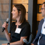A woman speaking on a microphone at an event