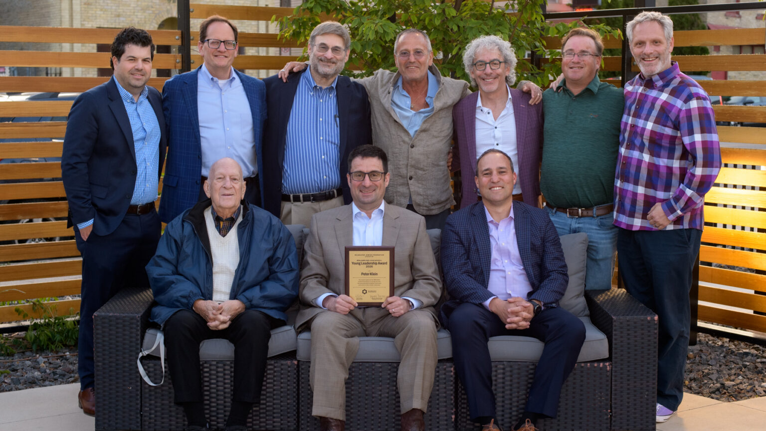 A group of past award recipient men smiling