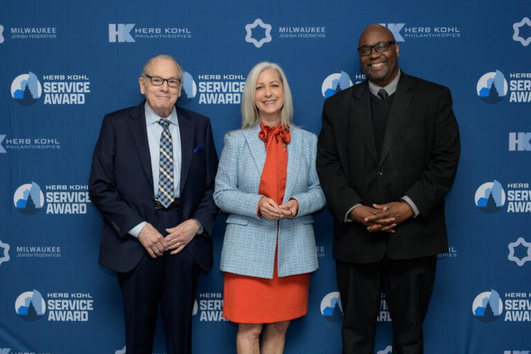keynote speaker and award recipients posing for a photo