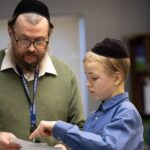 Teacher helping student