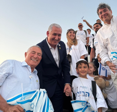 JAFI members posing for photo holding Israel flags.
