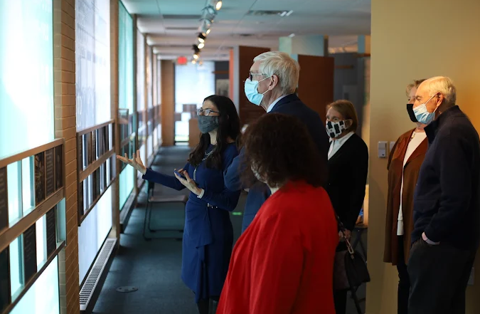 a woman leading a museum group tour