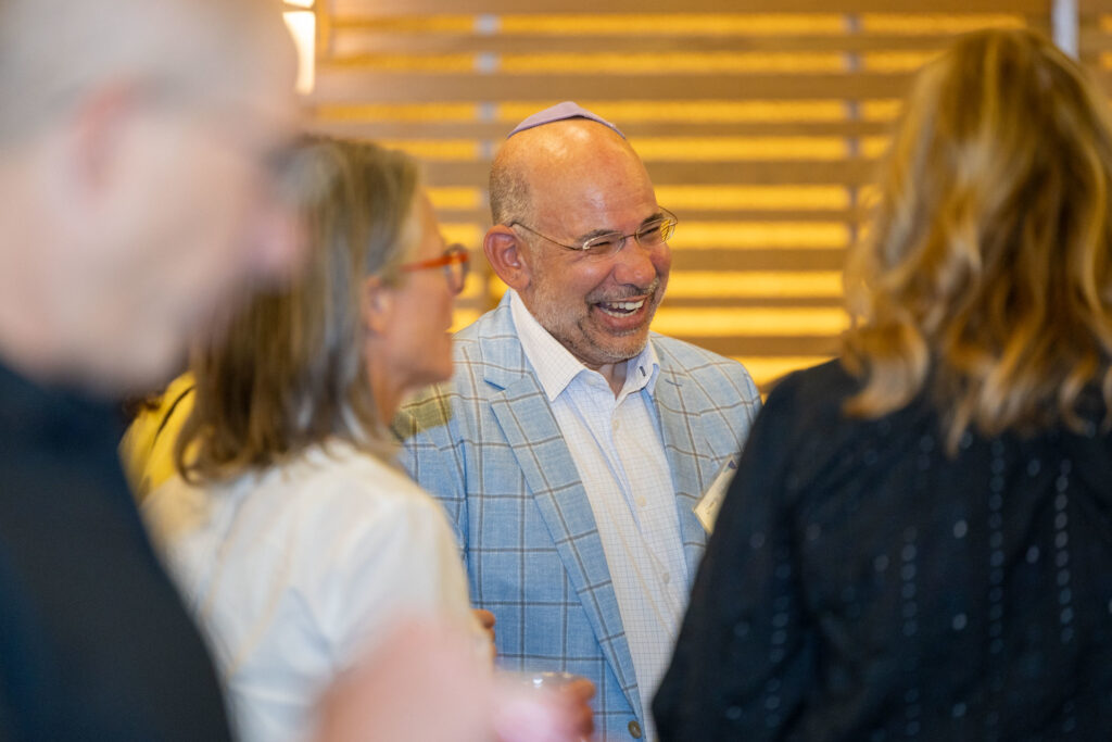 Crowd of people talking and laughing.