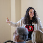 a woman speaking in front of audience