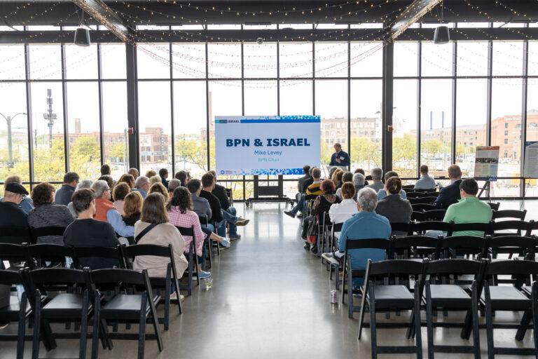 A crowd viewing a presentation.