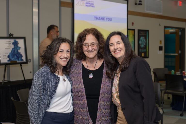 A group of three women smiling
