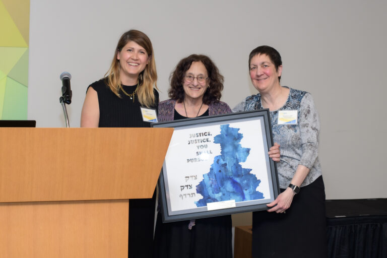 a woman being presented with an award