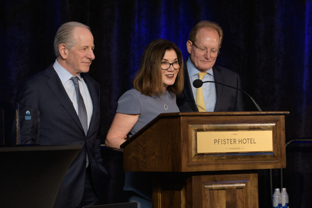 three professional business leaders speaking at event