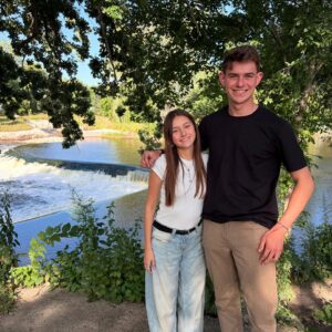 two people in front of a river waterfall