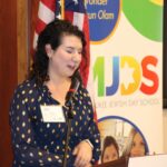 Director of Teen Initiatives talking at podium.