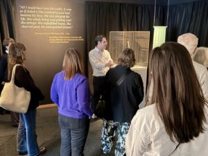 a man leading a museum group tour