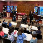 A teacher presenting to a group of kids