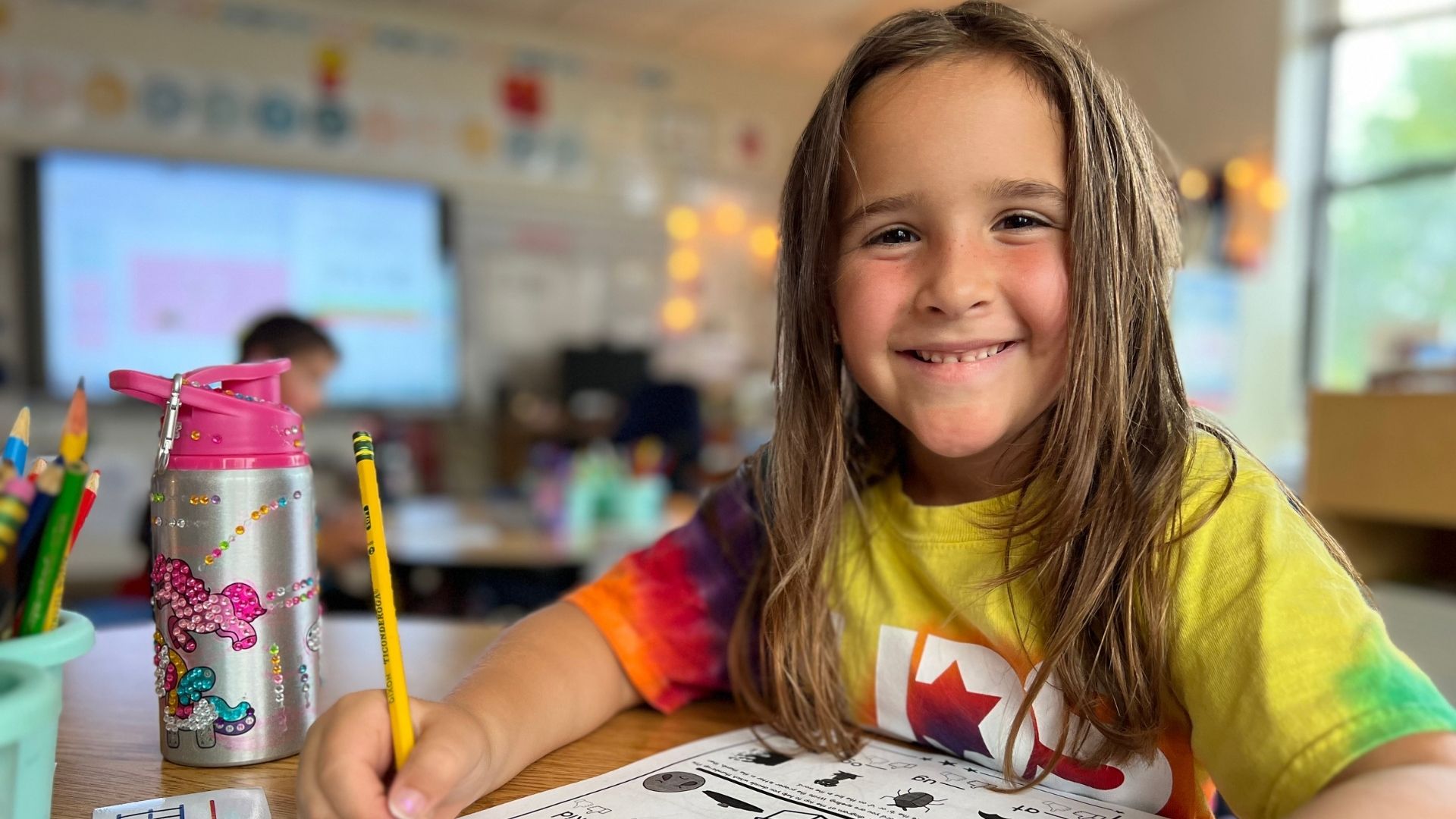 girl smiling while doing school work