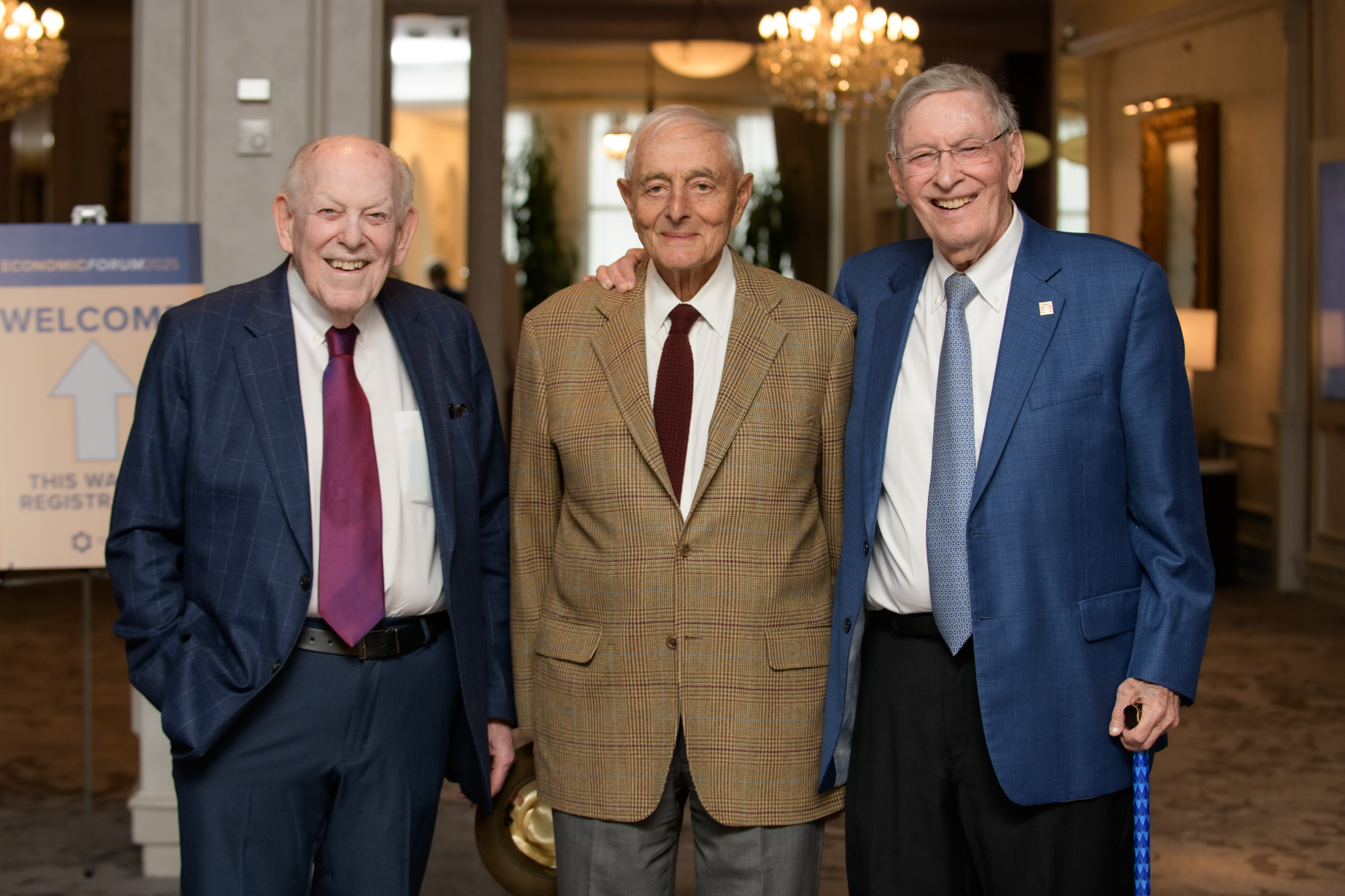 Three gentlemen in suits smiling