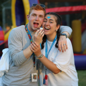 young man and woman smiling and eating