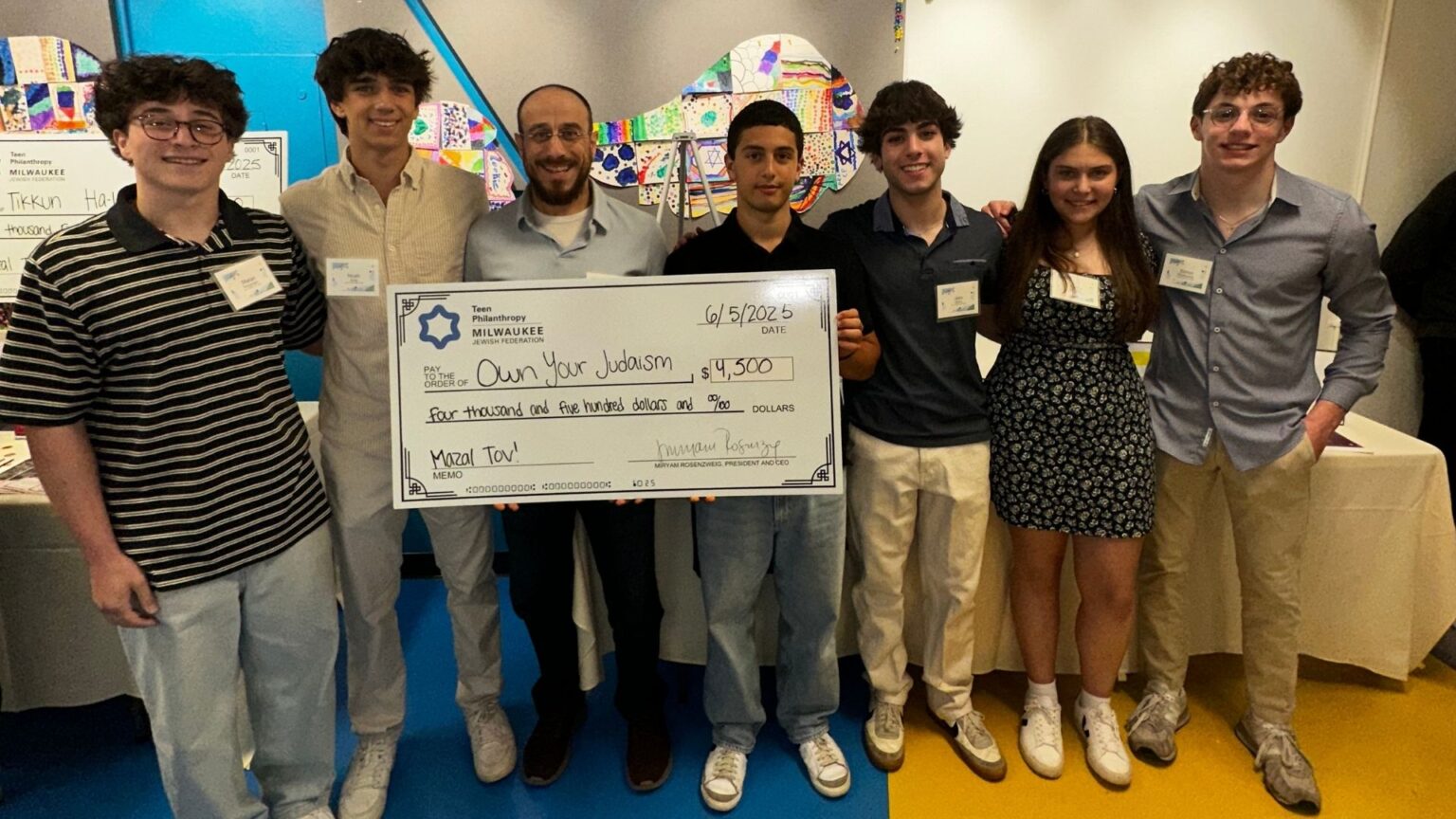 Group of teenagers and man smiling