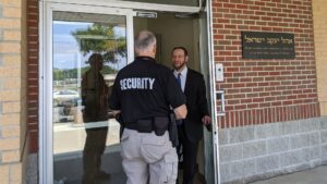 Teacher greeting a security guard at a school
