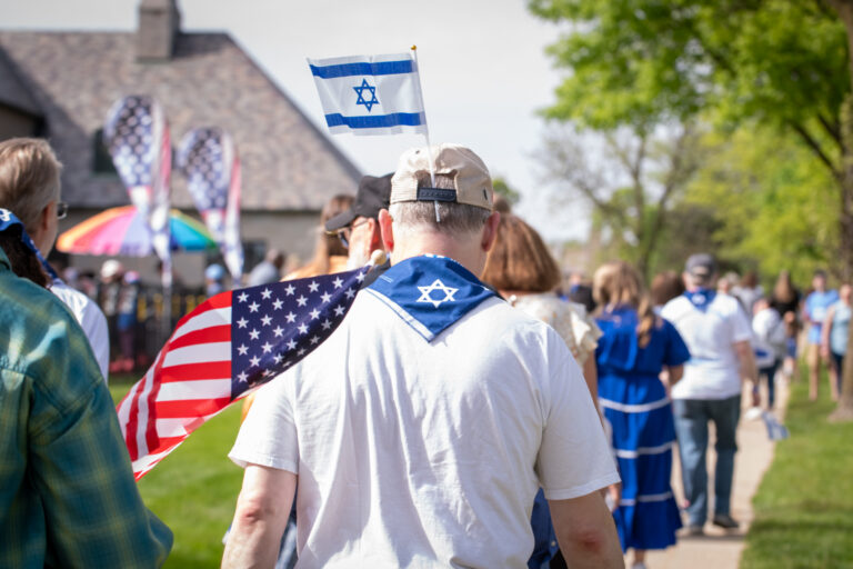 Israeli and American flag on man