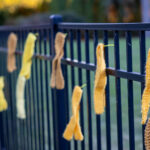 Yellow ribbons on fence.