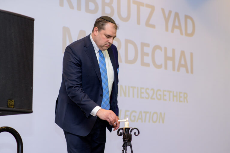 A rabbi lighting a candle