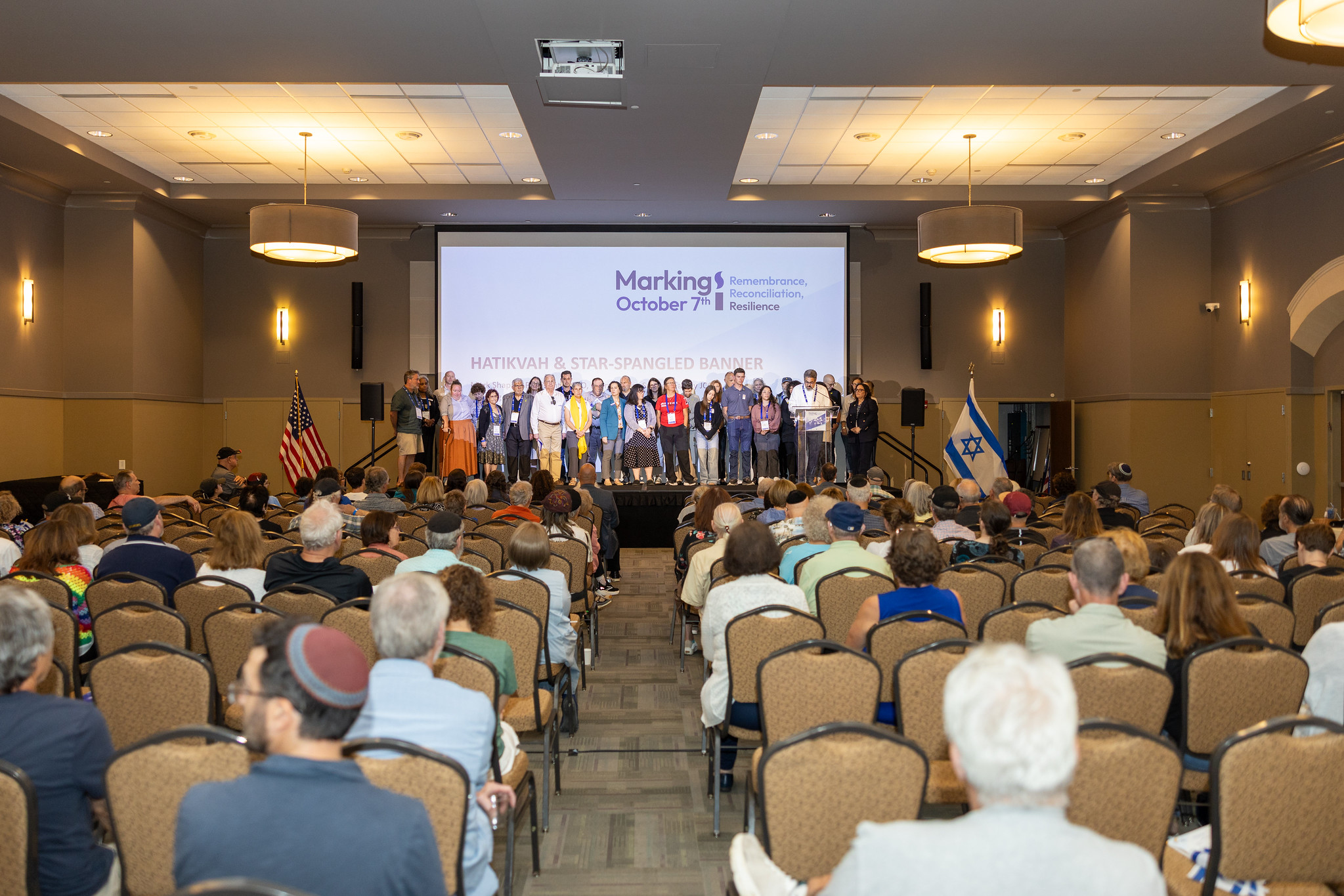 A group of people on stage in front of audience